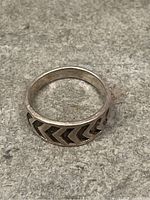 Top view showing the chevron pattern etched around the silver ring band.