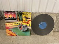 Front album cover of A Flock of Seagulls vinyl record showing colorful illustration with seagulls and room with TV.