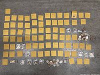 Full display of coin collection with multiple labeled envelopes and loose coins.