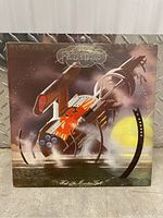 Photo of 'Hall of the Mountain Grill' album cover with abstract mechanical design and band name Hawkwind.