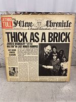 Front cover of Jethro Tull Thick As A Brick album jacket, designed as a newspaper front page titled 'The St. Cleve Chronicle & Linwell Advertiser' with a family photo and headline.