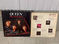 Front and back of Queen Greatest Hits vinyl album jacket featuring band photo and track details.