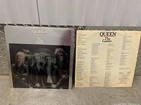 Front cover of Queen The Game vinyl album with photo of the band and title