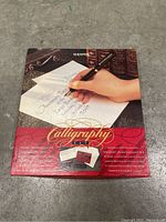 Top view of closed Sheaffer calligraphy set box showing packaging art and calligraphy sample on front.