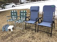 Photo of all six items grouped outdoors on grass with snow in background. Two webbed chairs on left, two padded folding chairs on right, and two stools in front (folding blue and white plastic).