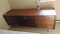 Front view of entire sideboard credenza showing top, drawers, cabinet doors and metal legs