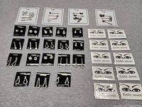 Overview photo of the lot showing multiple pairs of rhinestone earrings on branded card backings and assorted decorative hairpins arranged on a gray surface.