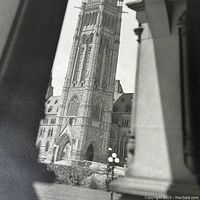 Close-up view of the clock tower of the Canadian government building from the photograph.