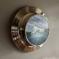 Side angle view of the chrome-plated porthole frame mounted on wall