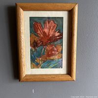 Front view of the framed watercolour painting showing signed maple leaves in fall colors.