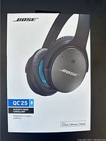 Front of sealed Bose QC25 headphones retail box showing model name, image of headphones, QC25 and noise cancelling label