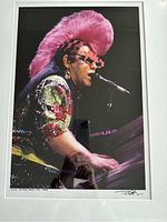 Full view of framed and matted photograph of Elton John at keyboard