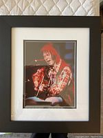 Frontal view of framed photograph showing full image, mat, and frame.