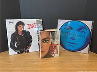 Overview of book and two vinyl records displayed upright