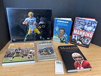 Overall arrangement of Aaron Rodgers signed photo with five football books