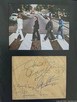 Frontal view of mounted Abbey Road image above the autographed page