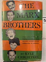 Front cover of the dust jacket showing colored caricatures of the Marx Brothers and title.