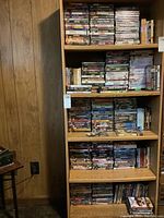 Overview of five wooden shelves filled with DVDs