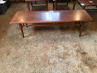 Full front view of table showing overall shape, legs and stretchers