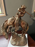 Front left angle showing rider raising rifle