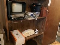 Photos showing AT&T Trimline telephone in box, loose telephone unit, Panasonic portable TV/radio, Maxon radio, and binoculars.
