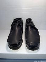 Front view of the pair of black leather Clarks men's shoes size 9