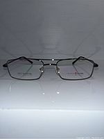 Front view of rectangular metal eyeglass frames with black temples, displaying frame details.