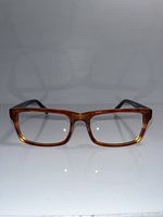 Front view of rectangular tortoiseshell eyeglass frames showing shape and color.