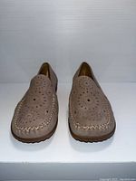 Front view of Gabor ladies shoes showing decorative perforations and stitched detailing on beige/taupe upper.