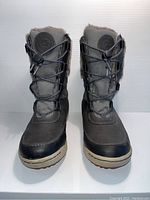 Front view of pair of grey Hi-Tec ladies winter boots with laces and beige soles