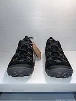 Front view of pair of black Hi-Tec outdoor shoes with visible elastic bungee laces and rubber outsole.