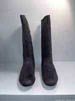 Front view of the black suede kids boots showing the tall shape and round toe.
