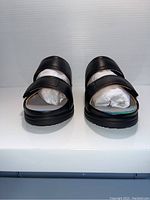 Front view of the pair of black ladies comfort shoes with straps and cushioned interior.