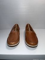 Front view of the brown Naturalizer ladies shoes showing moccasin style toe and white accented sole.