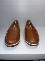 Front view of a pair of brown Naturalizer ladies loafers, size 8, showing moc toe stitching and striped detail on top