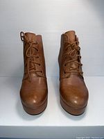 Front view of brown leather lace-up ankle boots, size 7.5, in brand new condition.