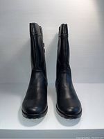 Front view of black kids boots showing smooth leather upper and rounded toe.