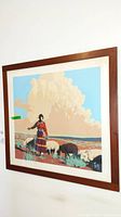 Overall view of framed lithograph depicting Native American figure and sheep against landscape.