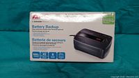 Photo of the APC Battery Backup packaging showing product image and specifications.