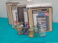 Three new Maurice brand fabric closet organizers still in packaging, beige and brown colors, standing upright.