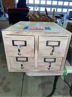 Front view of the wooden 4-drawer box showing metal pulls and label holders on each drawer.