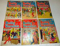 Six Betty & Veronica comic books laid out facing up showing covers with various scenes and titles consistent with issued numbers 151, 153, 155, 156, 158, and 189.