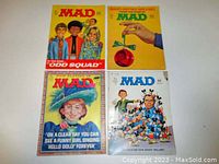 Front cover of all four MAD Magazine issues showing colorful, satirical artwork