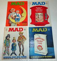Four MAD magazines laid out showing front covers of January, June, September, and October 1974 issues.