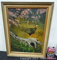 Full view of framed oil painting showing the turkey, log, and blooming branch with a pop can included in the photo for size reference.