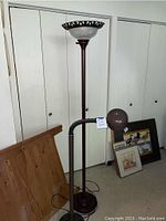 Full view of the tall standing lamp with the smaller swivel neck lamp attached, showing height and base.