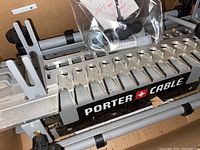 Close-up showing the clamps, slots and Porter Cable branding on the metal jig.