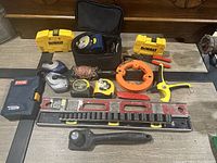 Photo showing the entire lot spread out on table with various hand tools and measuring devices.