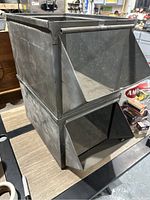 Two stacked heavy steel parts bins from rigging company, showing front access opening and overall shape.