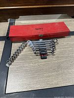 Red metal Husky case closed with tools displayed outside